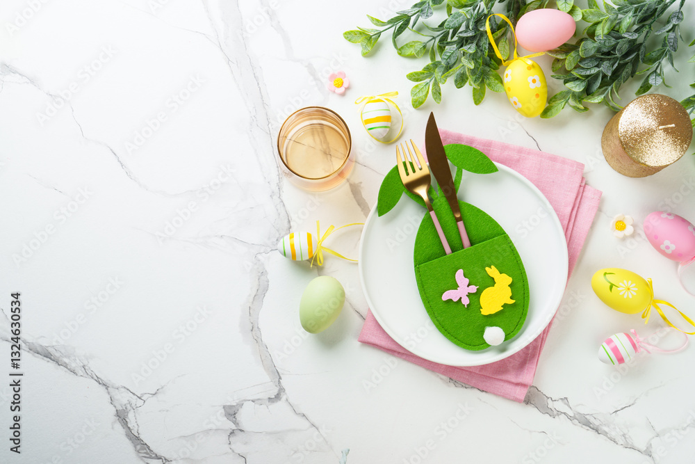 Easter table setting on white background with spring decorations.