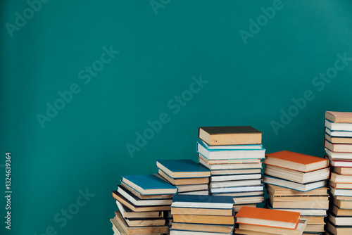 Stacks of old educational books on green library background