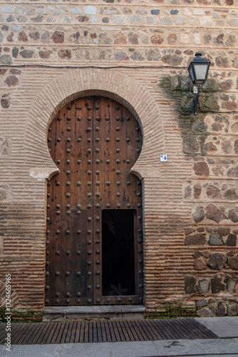 Facade and horseshoe arched door of the entrance to the Church of San Roman in Toledo. Spain
