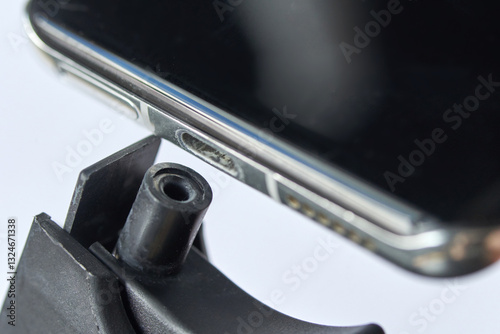 Valokuva Close up shot of smartphone with visible dirt in charging port on white background