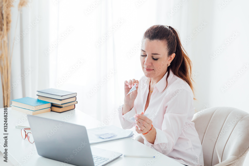 Business woman at desk with laptop learning games online Business woman at desk with laptop learning games online