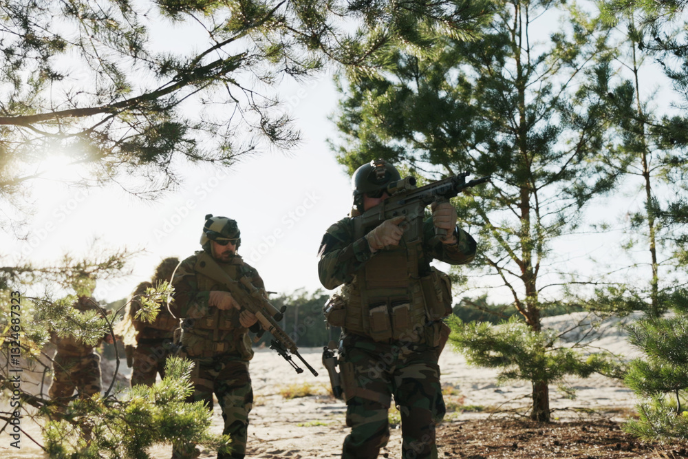 Fototapeta premium Soldiers dressed in moro uniforms, marching in a line with guns in hand, monitor the terrain, patrol the area, and engage in border security drills while training on the firing range.