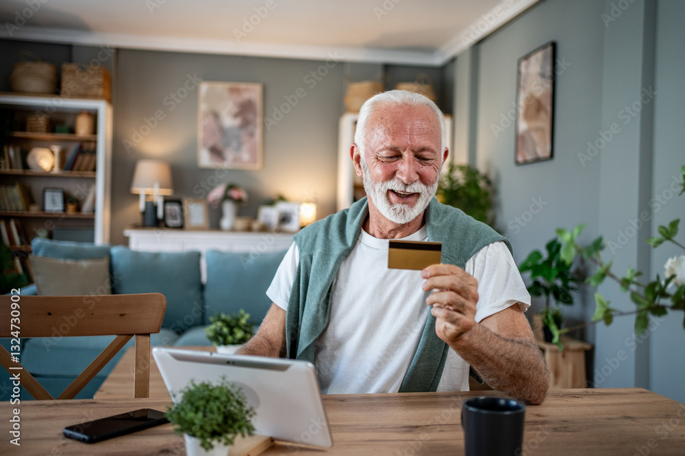 Smiling senior man using tablet and credit card for online shopping at home Smiling senior man using tablet and credit card for online shopping at home