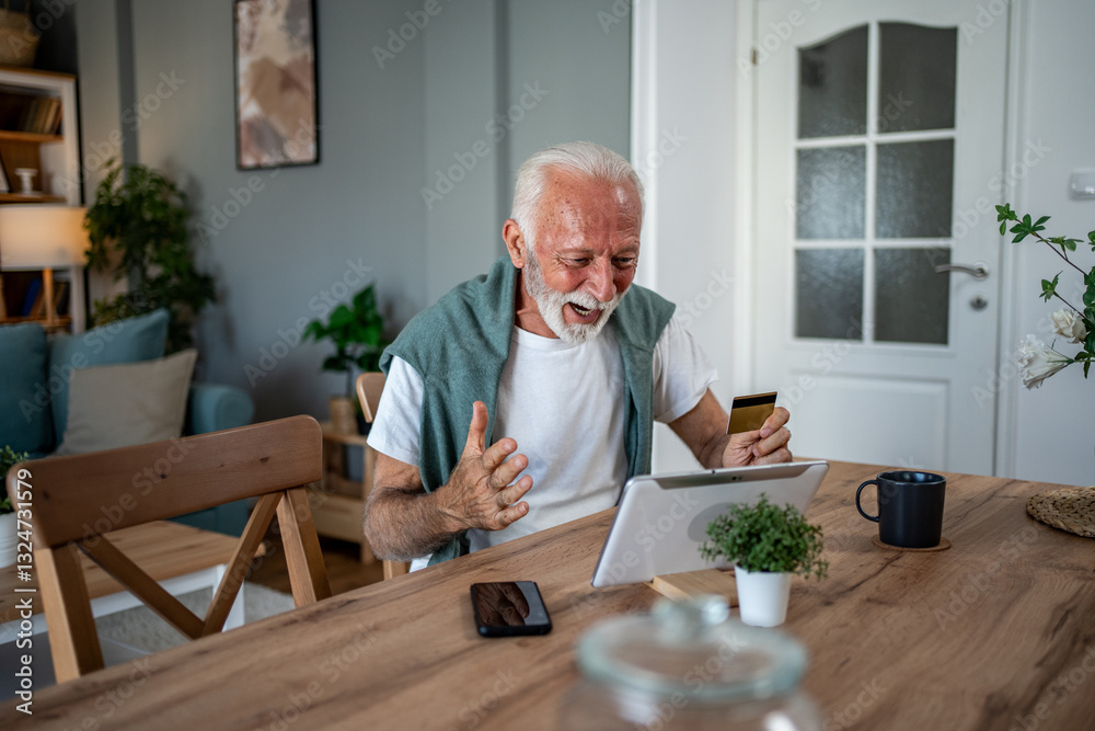 Excited senior man using tablet and credit card for online shopping at home Excited senior man using tablet and credit card for online shopping at home