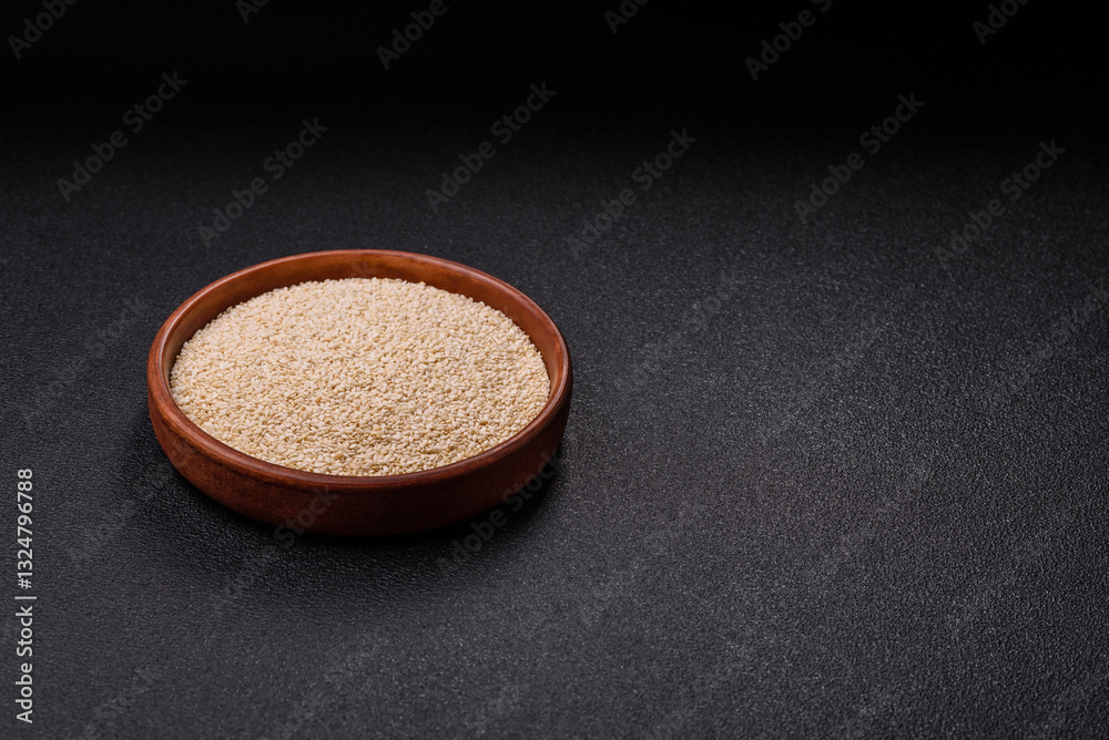 White sesame seeds in a bowl, an ingredient for making vegetarian food White sesame seeds in a bowl, an ingredient for making vegetarian food