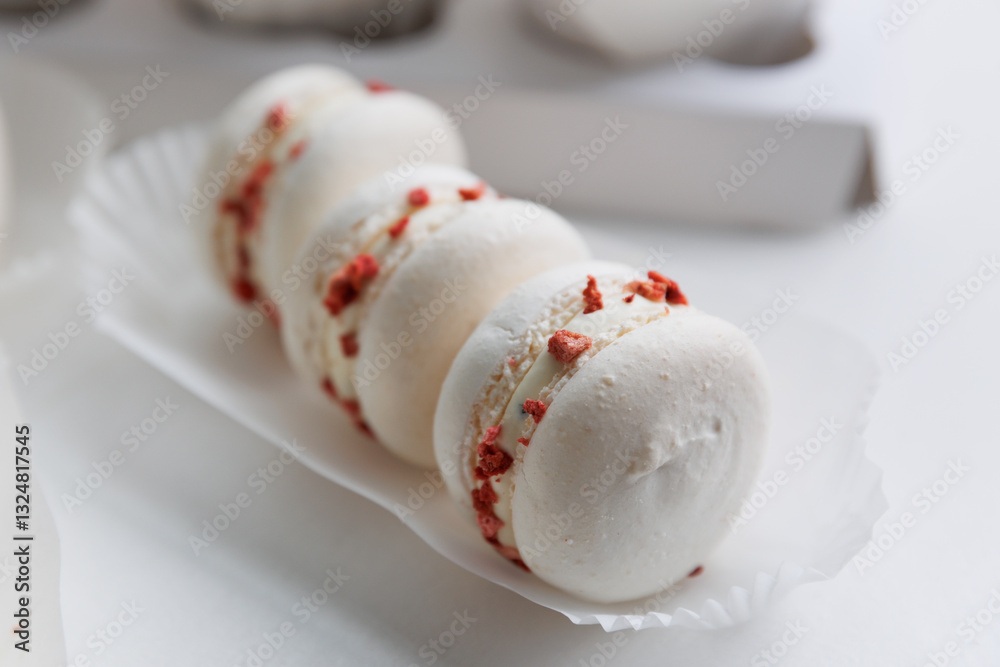 Fototapeta premium Dessert pasta. Sweet almond cookies with raspberries and cream on a white plate