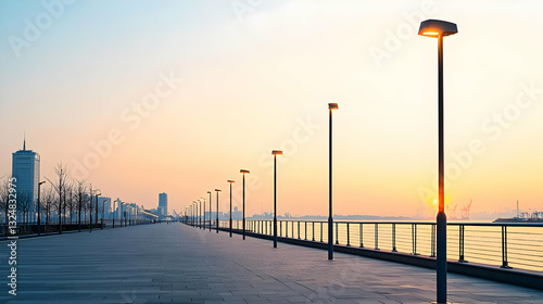 Panoramic View Of A City Promenade At Sunset With Street Lights And Buildings Reflecting On The Water Surface