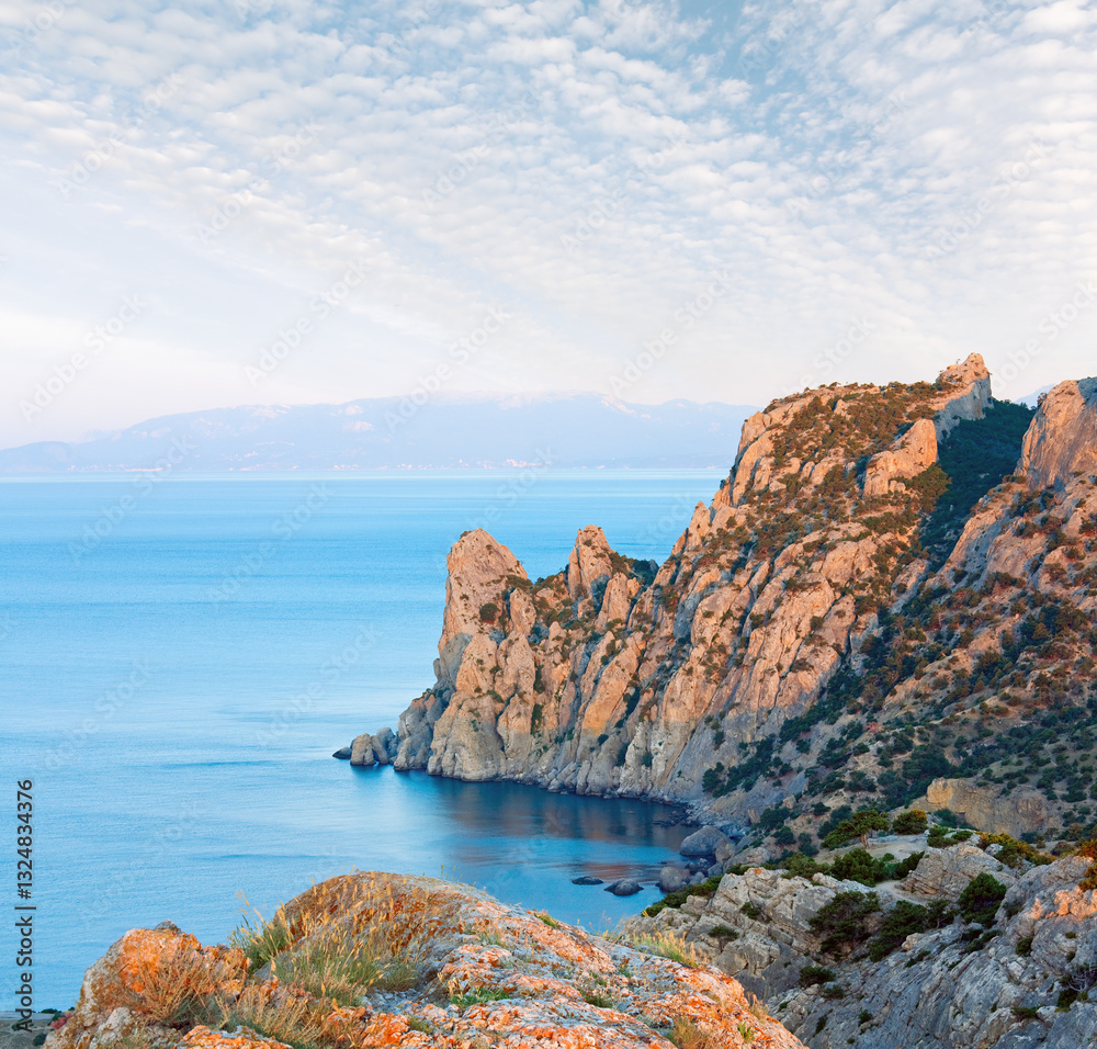 Daybreak above summer rocky coastline (