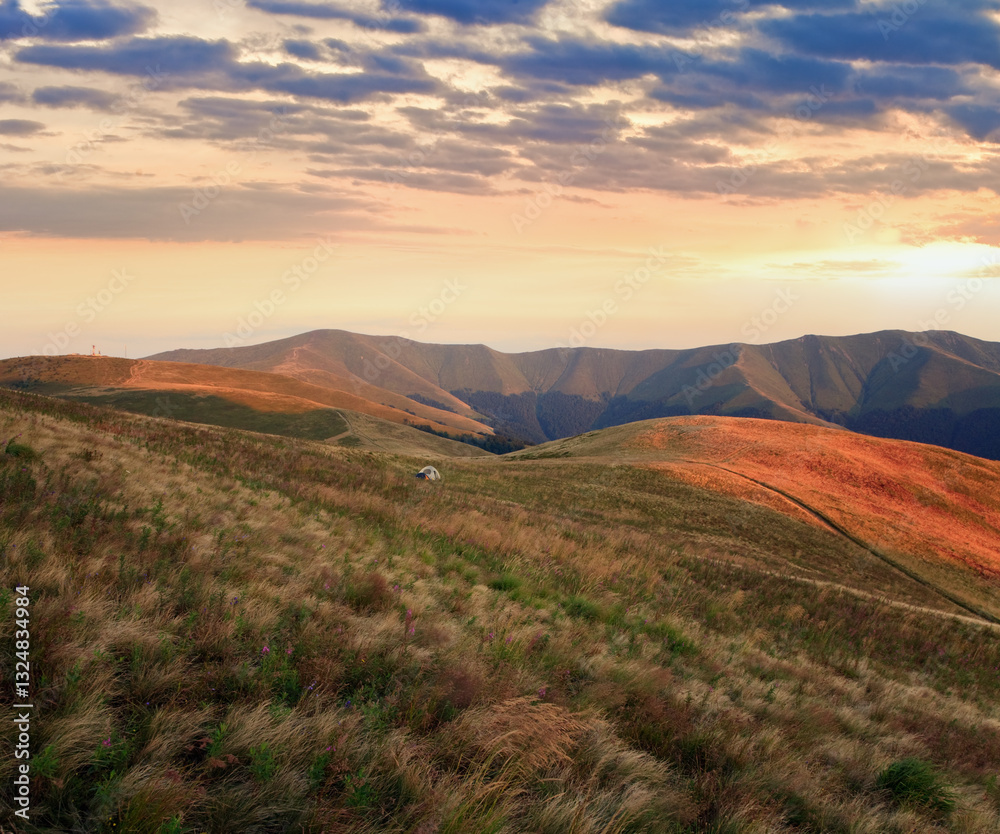 summer cloudy mountain landscape with tourist camp on slope (Ukraine, Carpathian Mountains)