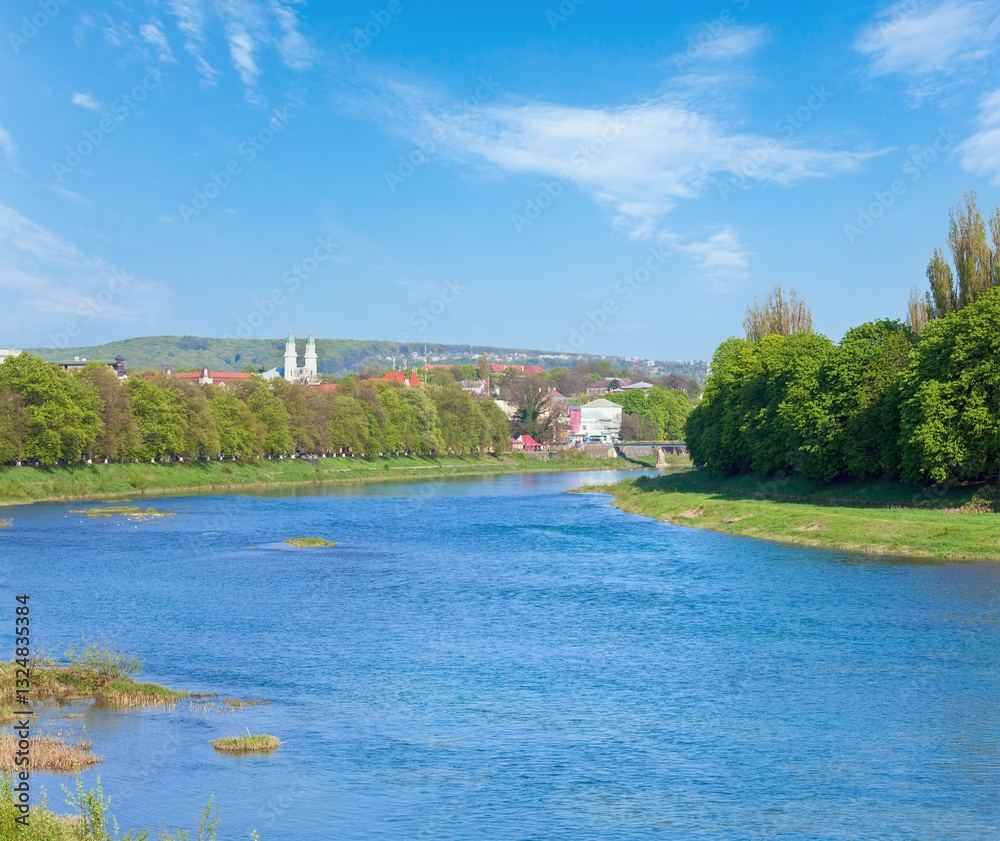 Day urban view with Uzh river and Greek Catholic Cathedral and Linden Avenue behind (Uzhgorod City, Ukraine)