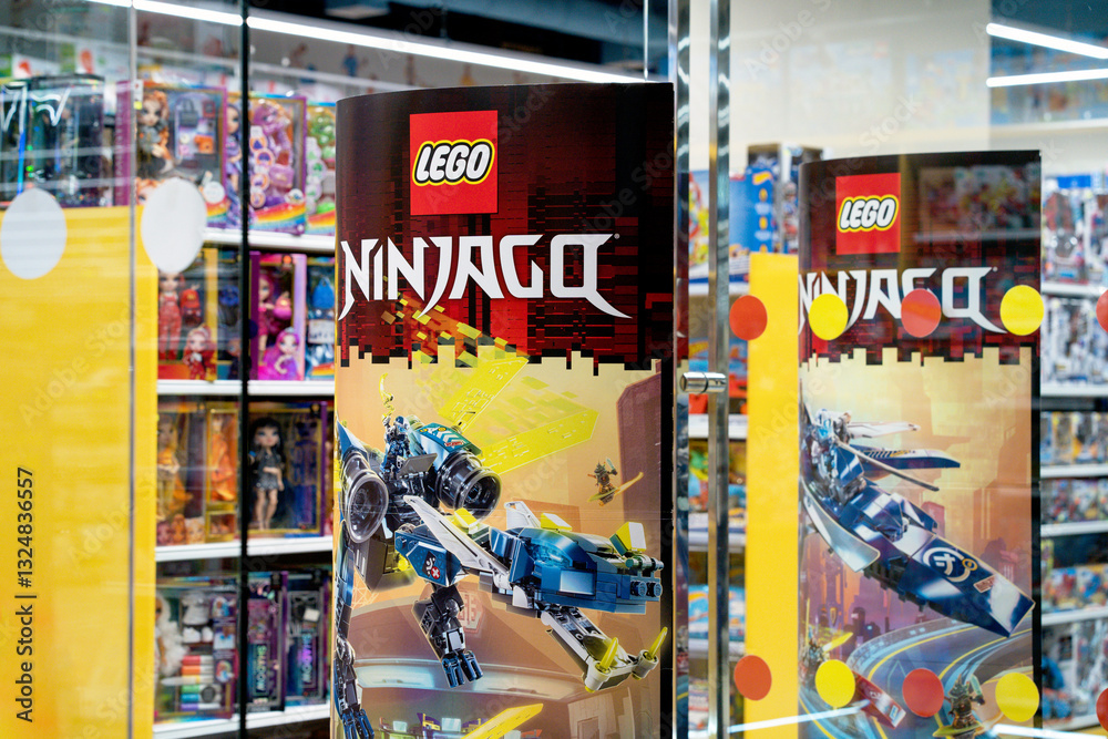 Naklejka premium Lego company advertising at the entrance to a toy store. Lego company logo on a promotional post. Minsk, Belarus - March 4, 2025