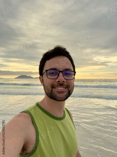 Man smiling at sunset in the ocean