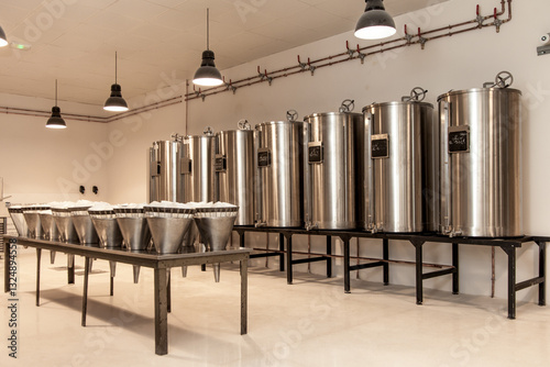 Картината върху платно A row of stainless steel tanks are lined up in a room in museum of perfume produ
