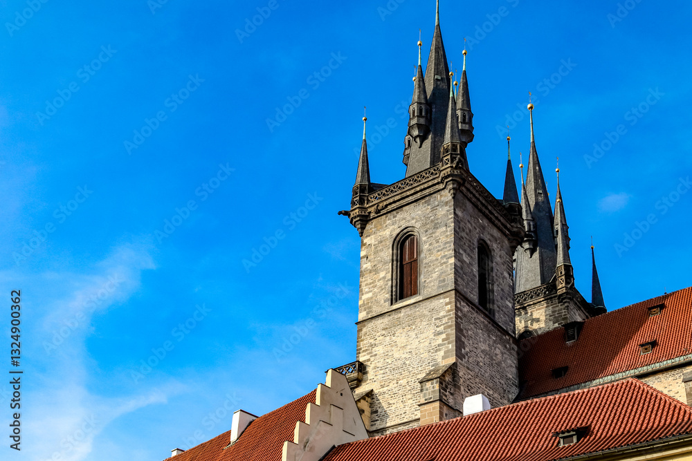 Fototapeta premium A tall building Temple of the Mother of God in front of the Tyn with a red roof and a blue sky in the background in Prague Czech Republic