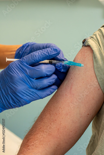 Healthcare worker administering vaccine shot.