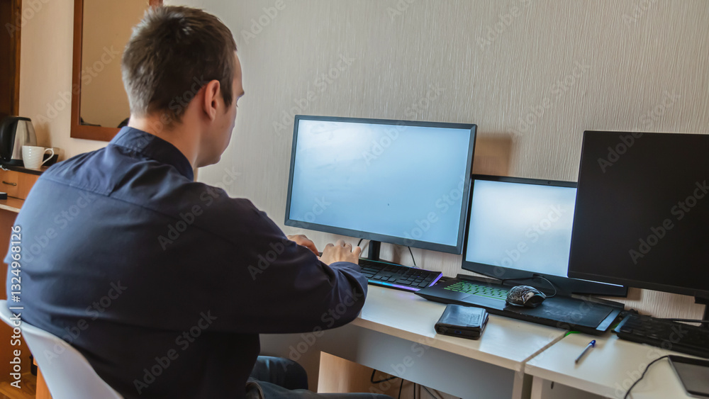 Young freelancer working on computer at home