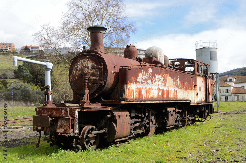 Naklejka premium Old and abandoned steam locomotive in a state of scrap, rust and rotten steel, a retrospective of the past in railways, transport