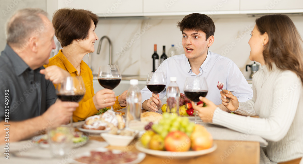 Happy family having dinner together at the festive table at home Happy family having dinner together at the festive table at home