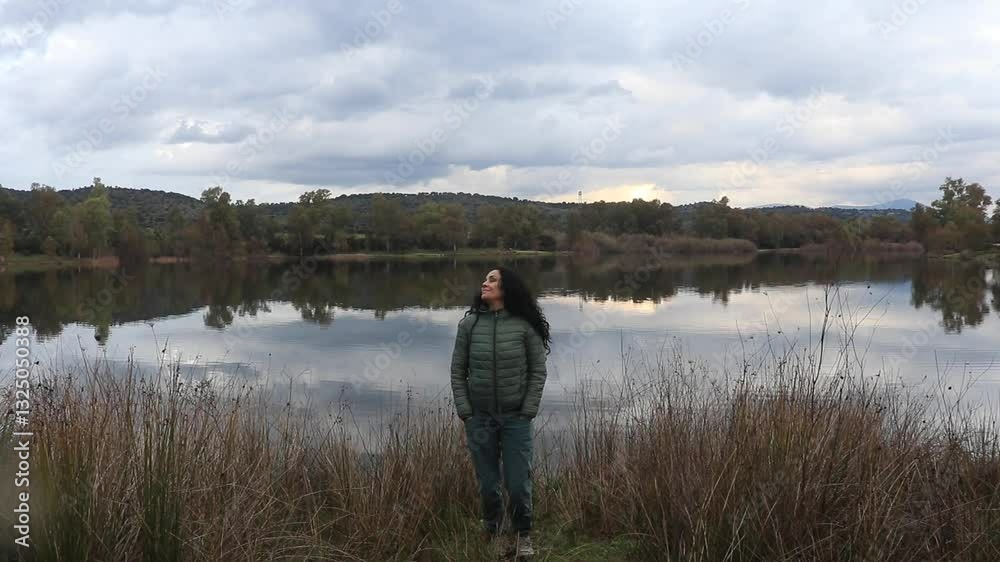 Brunette woman enjoying and having fun at a lake