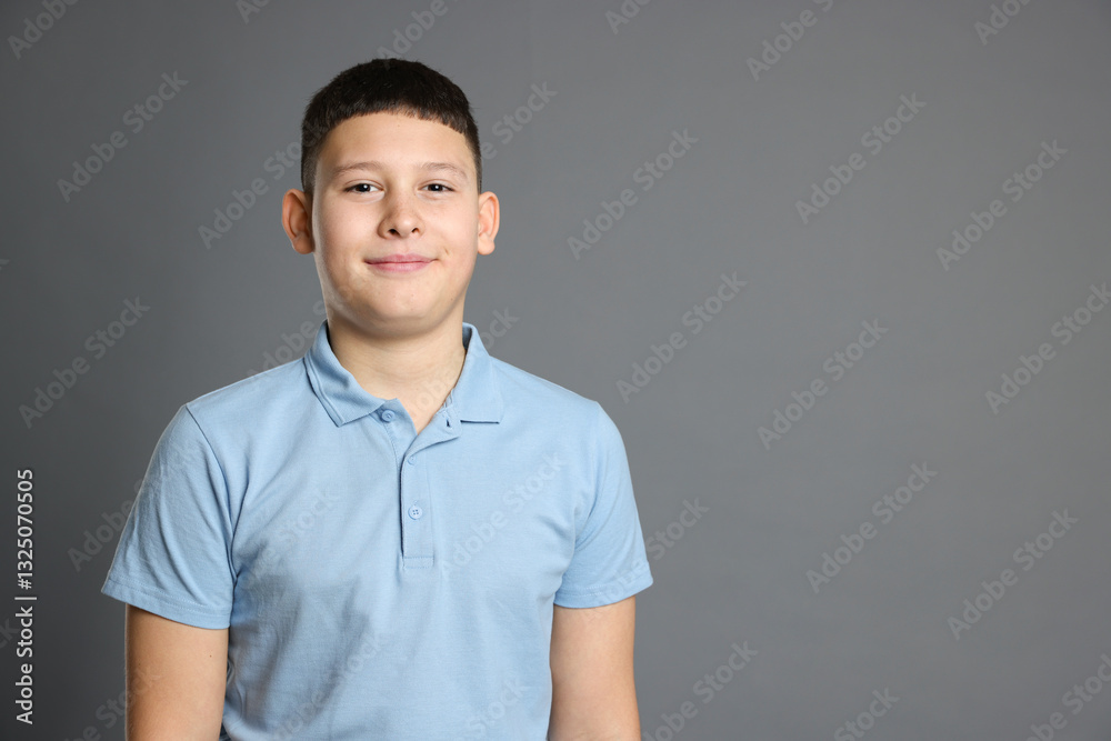 Portrait of teenage boy on grey background, space for text Portrait of teenage boy on grey background, space for text