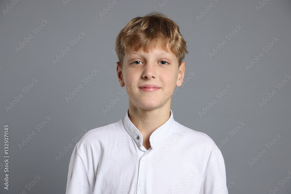 Portrait of teenage boy on grey background Portrait of teenage boy on grey background