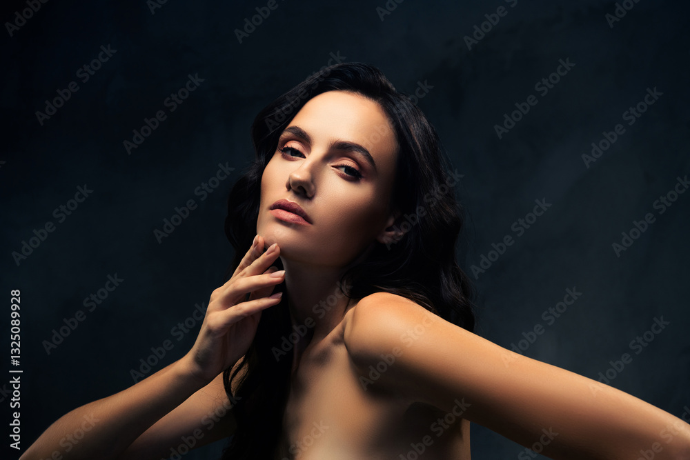 Fototapeta premium Portrait of a Young Beautiful Brunette Woman with Glamorous Makeup and Stylish Hair on a Dark Background