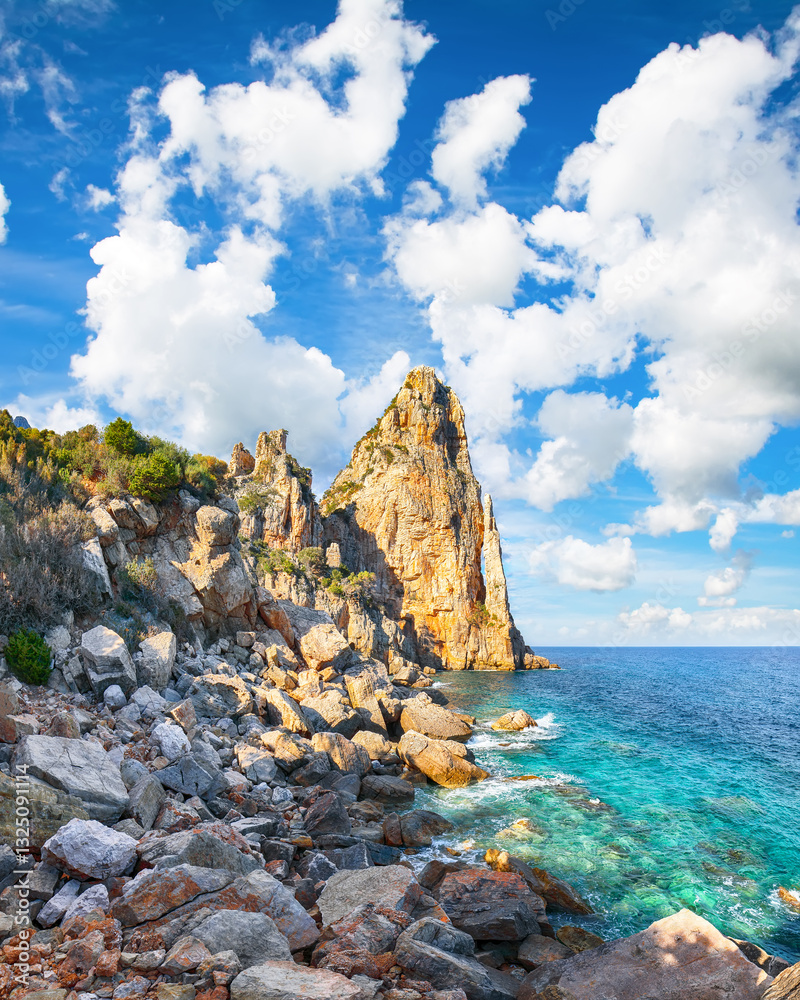 Remarkable view of Punta Pedra Longa and azure water in sea.