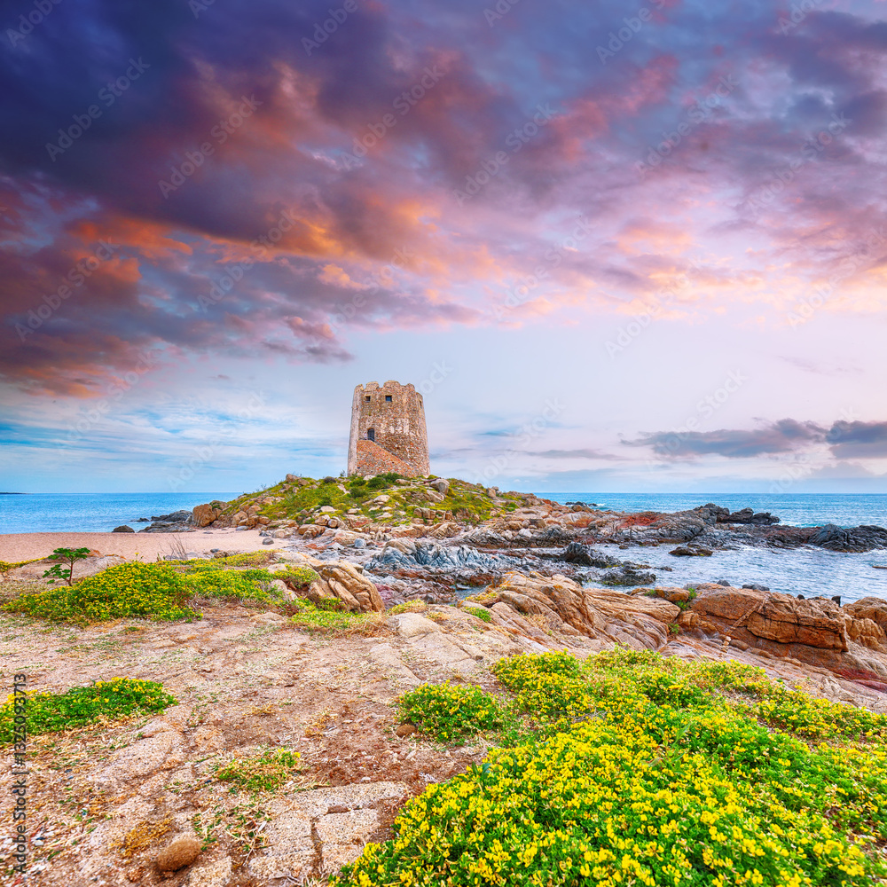 Exciting sunset view of Bari Sardo tower in the Gulf of Orosei.