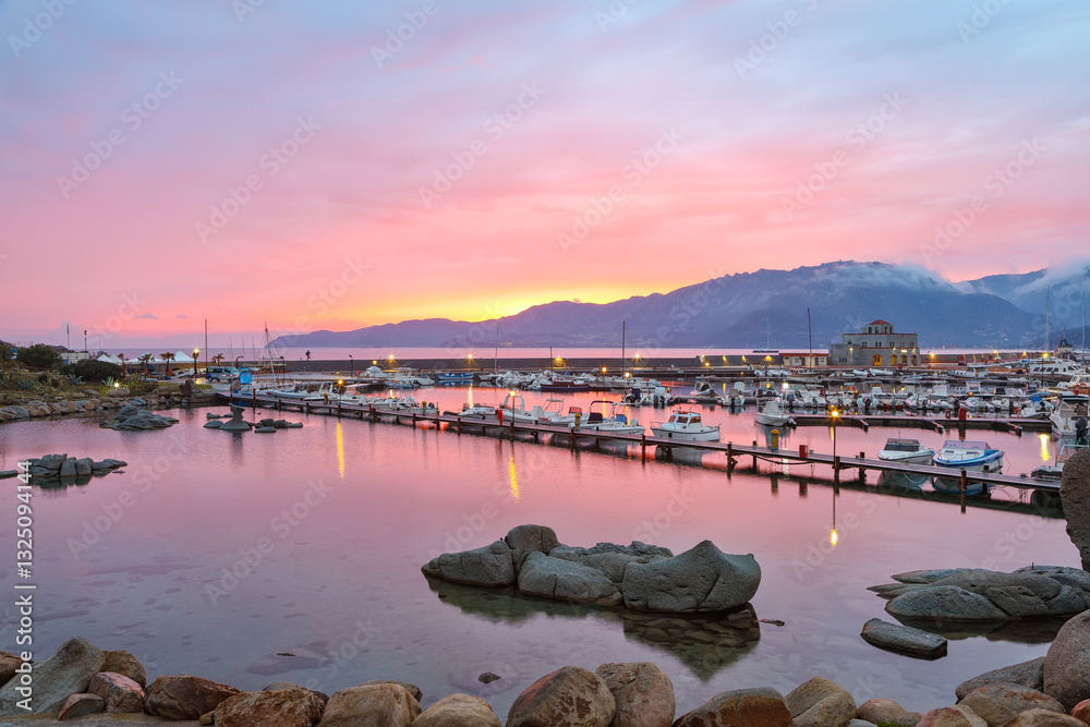 Remarkable sunset view on boats in beautiful marina of Villasimius.