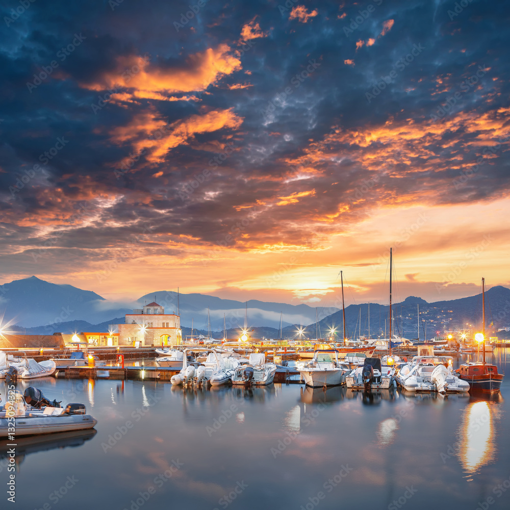Remarkable sunset view on boats in beautiful marina of Villasimius.