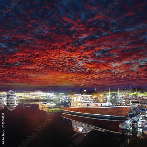 Obraz na płótnie Remarkable sunset view on boats in beautiful marina of Villasimius. w salonie
