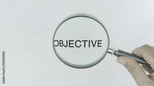 Objective, text, word, highlighted by a magnifying glass in a hand on a white background, symbolizing clarity, focus, and goal-setting through measurable targets