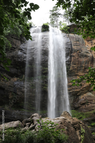 Majestic twin waterfalls cascading down a rugged rock face