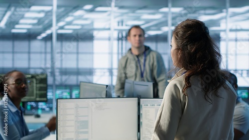 Fényképezés Manager overseeing server room holding impromptu meeting with employees