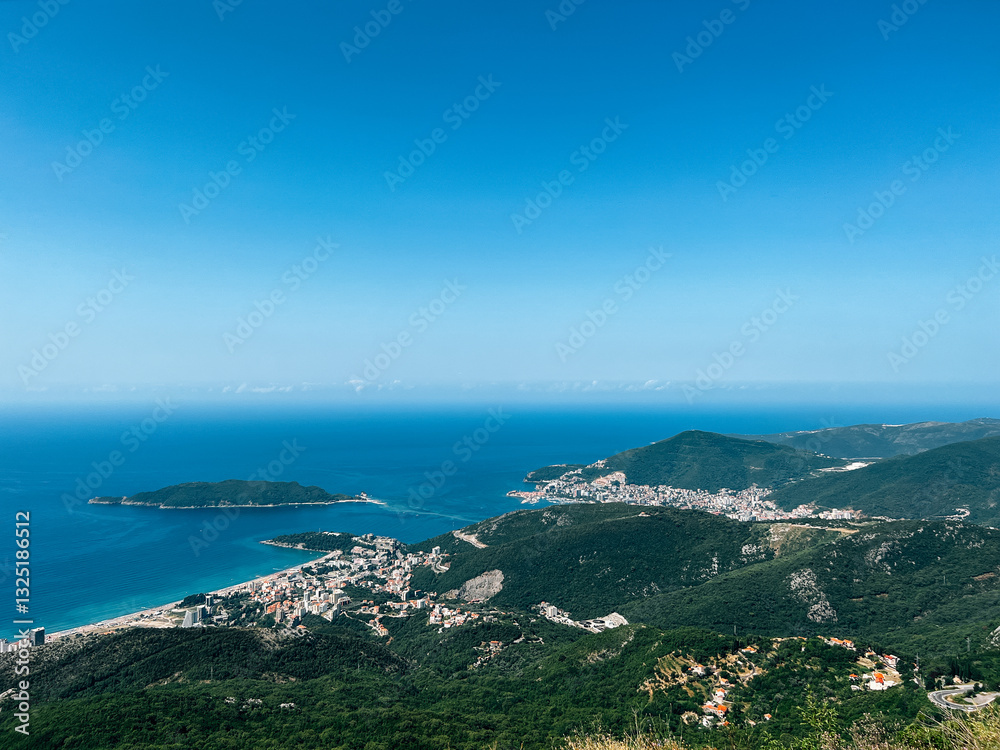 Mountain range near the blue sea merging with the clear sky Mountain range near the blue sea merging with the clear sky