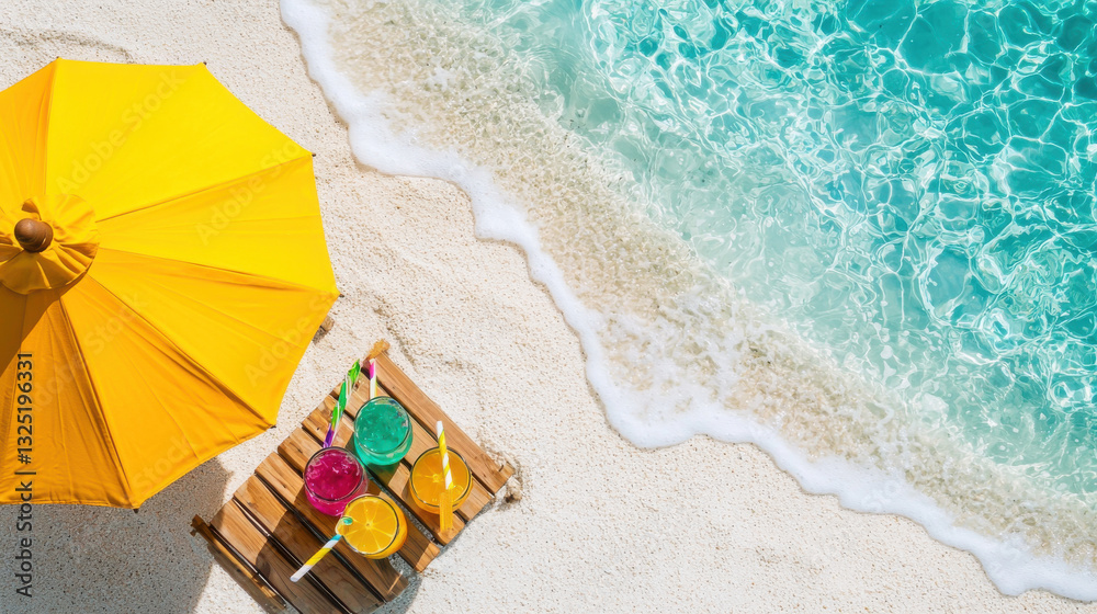 Fototapeta premium Bright yellow umbrella on sandy beach with colorful drinks by water