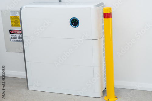 Large white battery for solar energy storage with fire warning sign