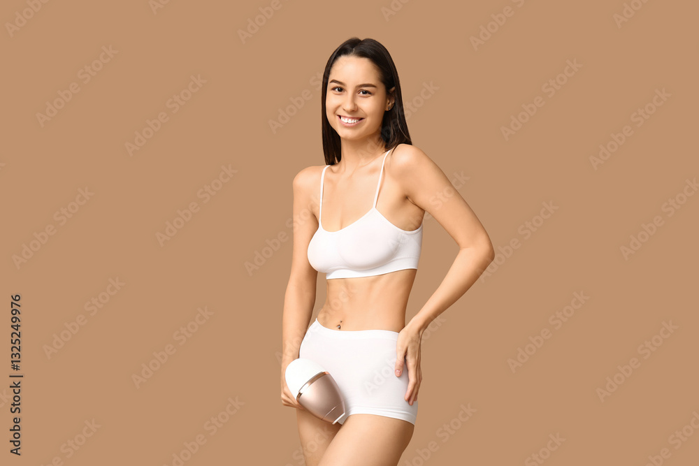 Obraz premium Happy young woman with modern photoepilator on brown background