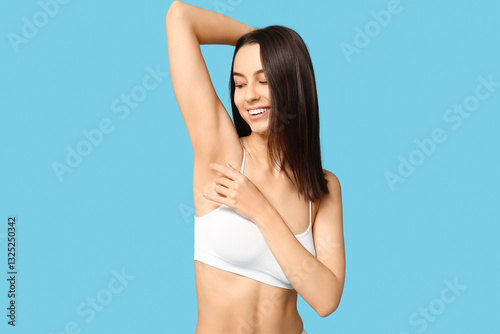 Beautiful young woman in underwear on blue background. Epilation concept photo