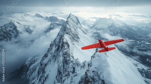 Red airplane on snowy mountain peak, aerial view.