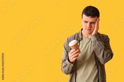 Tired young man with cup of...