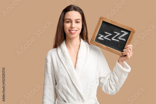 Young woman in bathrobe wit...