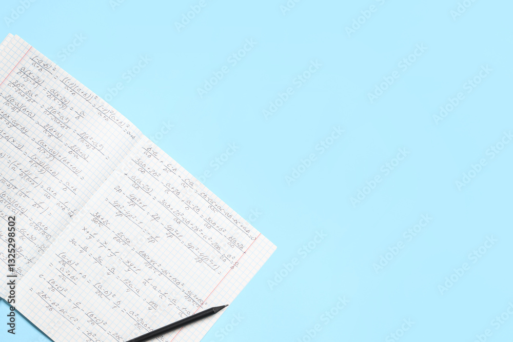 Fototapeta premium Copybook with handwritten maths formulas and pencil on blue background