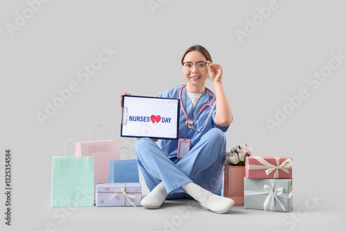 Female doctor holding clipb...