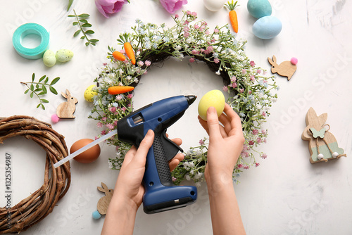 Woman decorating Easter wre...