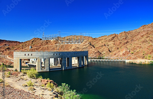 Lake Havasu above the Hydroelectric Power Parker Dam on the Colorado River and Lake Havasu, in Parker Dam, California, USA with blue sky copy space and transmission towers in the background.