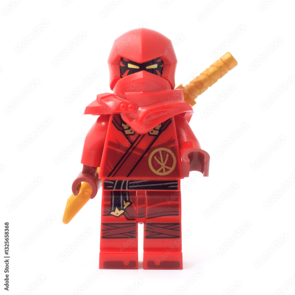 Naklejka premium Editorial illustrative image of lego ninjago minifugure of Kai red ninja with golden sword weapon on blue background