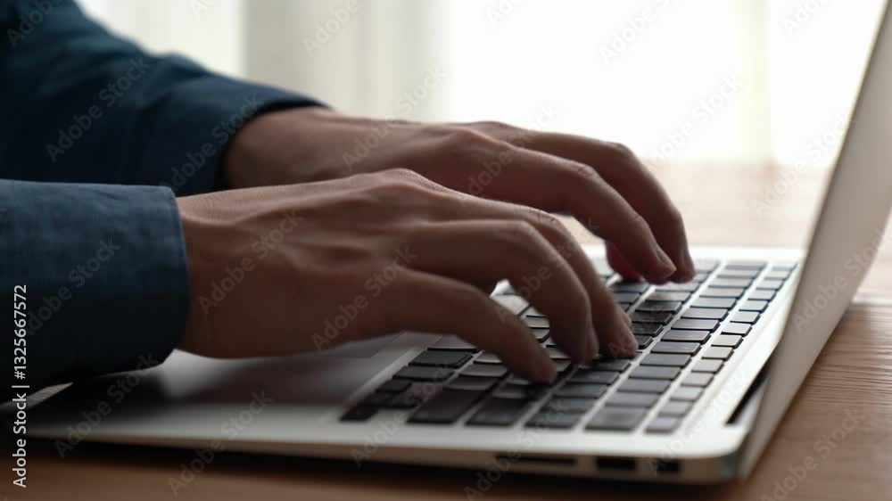 Businessman hand work on capable laptop computer at office table close up shot and selective focus at middle section of laptop computer keyboard while typing and working Businessman hand work on capable laptop computer at office table close up shot and selective focus at middle section of laptop computer keyboard while typing and working