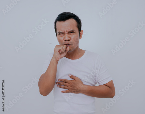 Strongly coughing young man wearing white t-shirt suffered from asthma, isolated on white background.