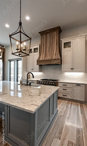Modern kitchen interior featuring elegant cabinetry, marble countertops, and stylish lighting fixtures